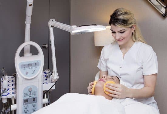 A chemical peel being applied to a client's face in a treatment room