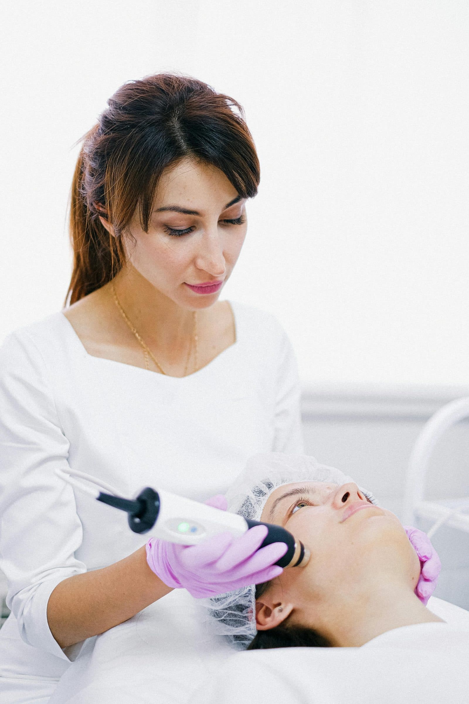 A practitioner performing an RF microneedling treatment in a clinic — one of the techniques taught in the CCAD curriculum